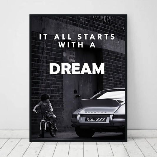Inspirierendes Poster von justgoodmood mit dem Titel "Schwarz Weiß Luxus Geschäfte und Fahrzeuge als Deko Print ohne Rahmen". Es zeigt ein Kind auf einem Fahrrad neben einem eleganten, klassischen Auto, das den Satz "It all starts with a DREAM" in einer stilvollen Schrift betont.