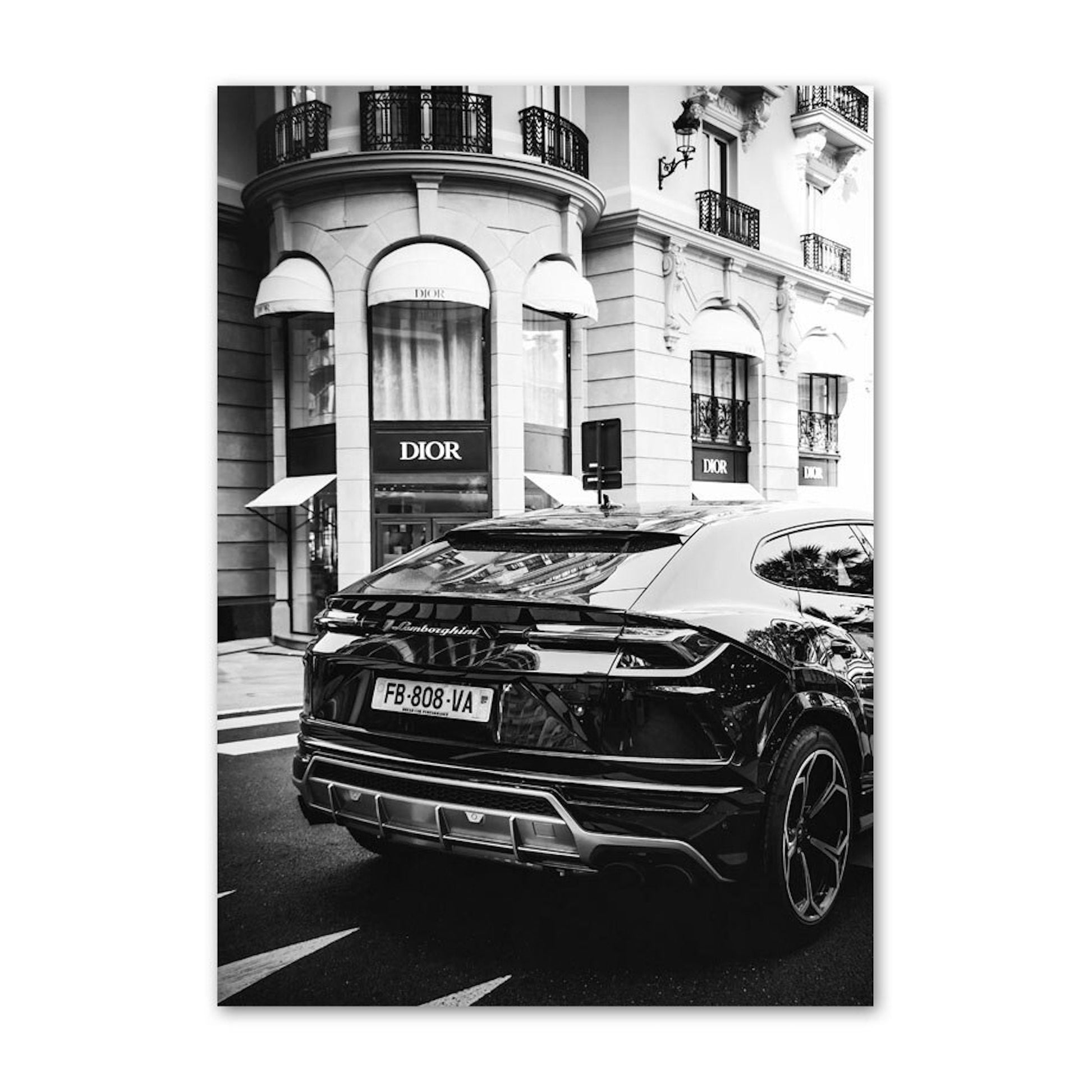 Schwarz Weiß Luxus Geschäfte und Fahrzeuge Poster von justgoodmood – zeigt einen eleganten Lamborghini vor einem Dior-Geschäft, ein wahrhaft luxuriöses Ambiente.