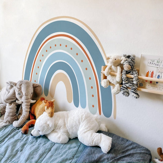 Bunter Boho-Stil Regenbogen Wandaufkleber von justgoodmood im Kinderzimmer, umgeben von Kuscheltieren, ideal für die Wanddekoration in einem Babyzimmer.